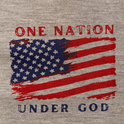 A close-up product shot of a gray t-shirt with a distressed patriotic graphic featuring a U.S. flag and the text 'ONE NATION UNDER GOD'.